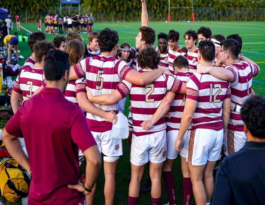 FSU Rugby team huddle on the sideline before a match